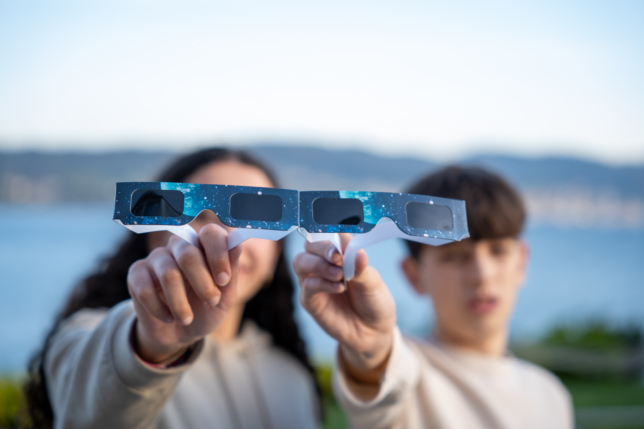 Dos adolescents mostres unes ulleres per veure l'eclipsi.